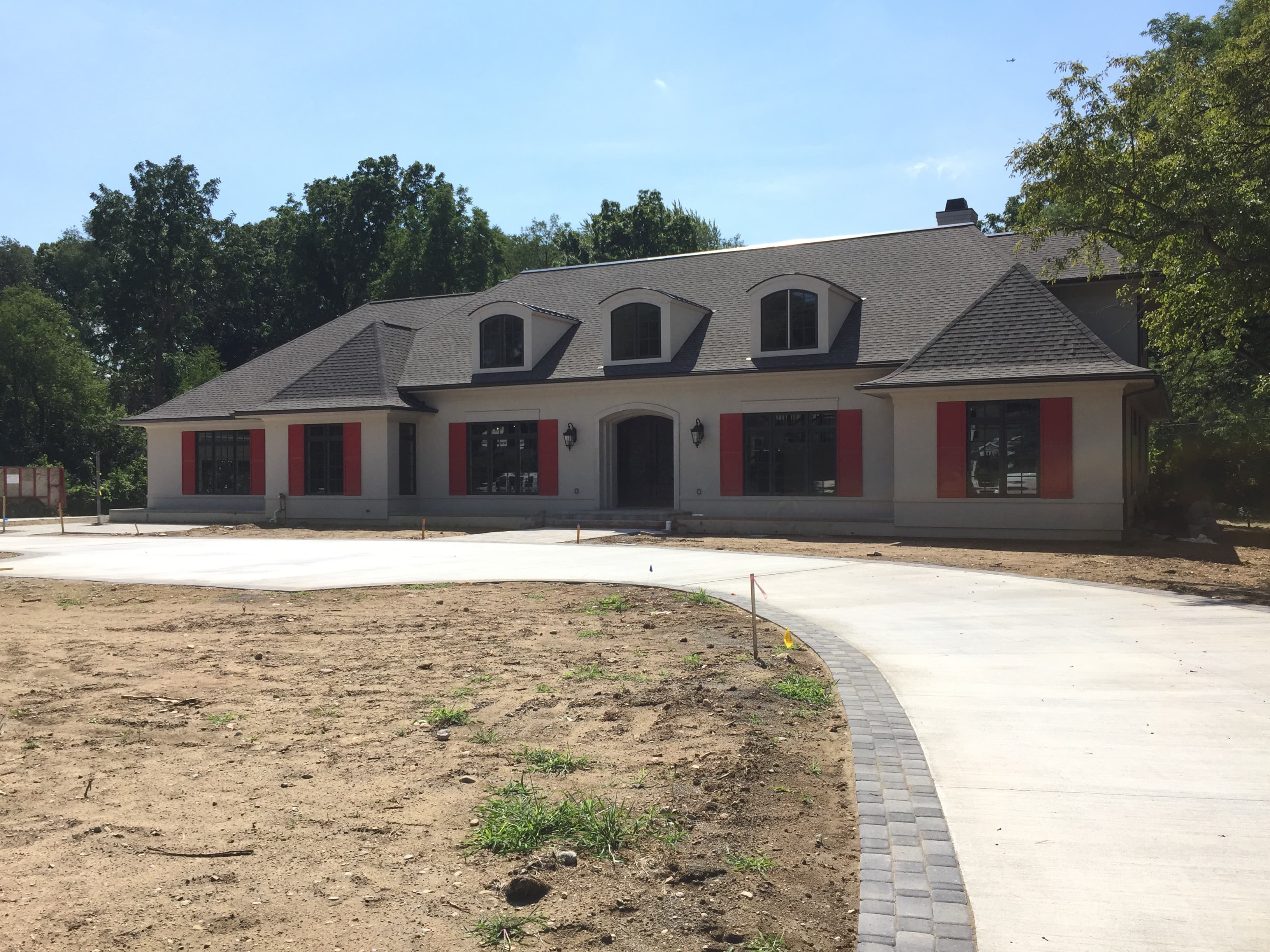 Before: freshly poured driveway and walkway, construction phase complete